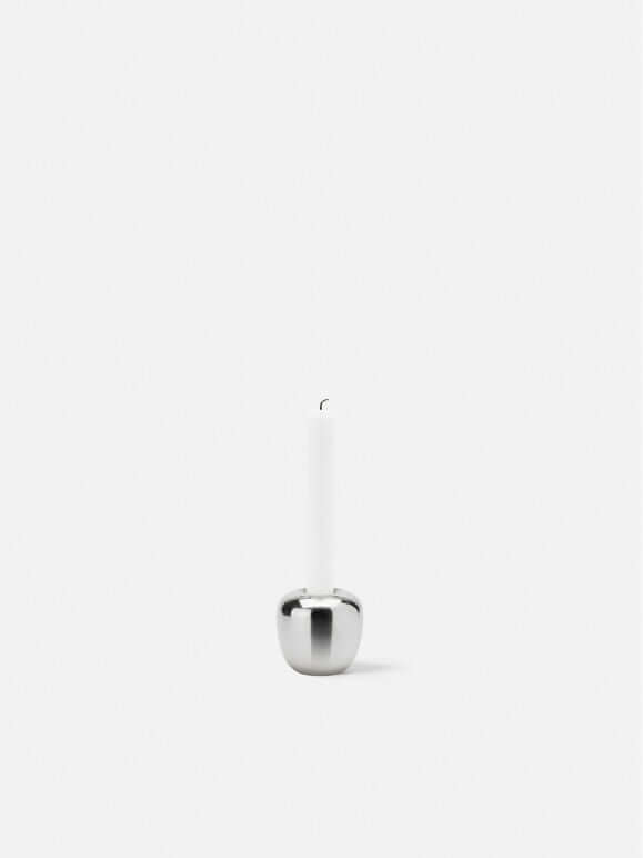 Stelton Ora Candleholder featuring a sleek design with a white candle and a polished base.